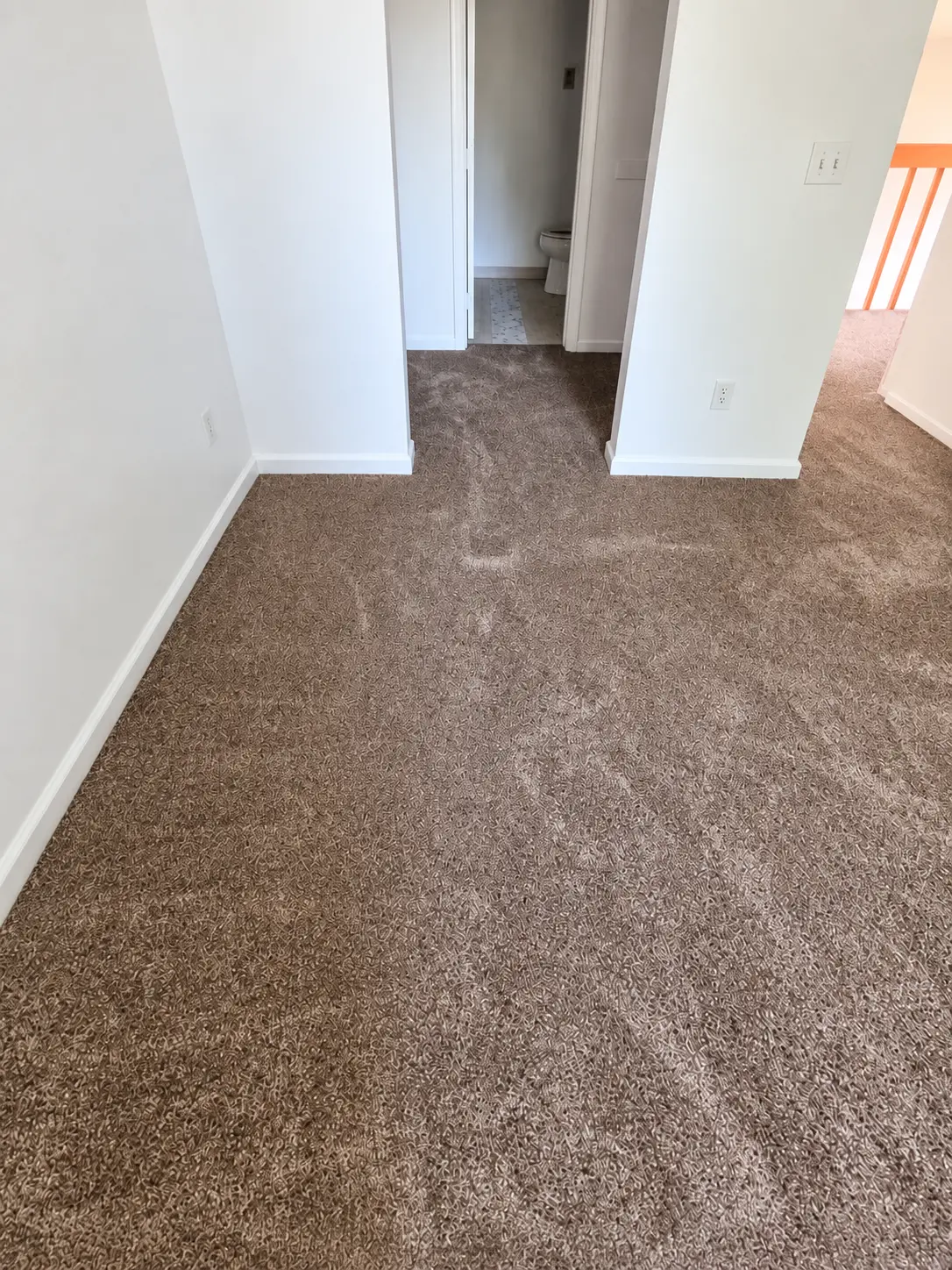 Brown berber carpet on an upstairs landing