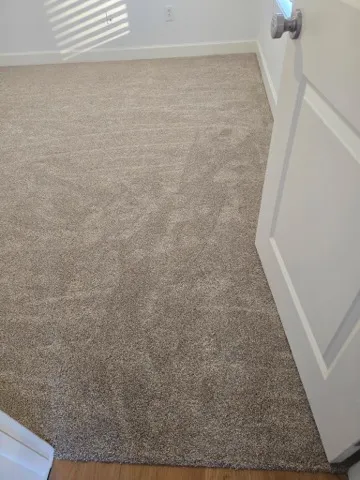 Newly installed carpet in a bedroom seen through the doorway
