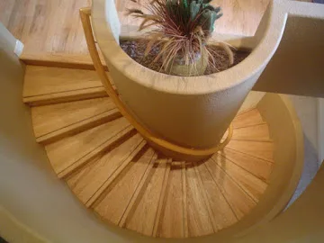 Curved oak spiral staircase with a curved handrail