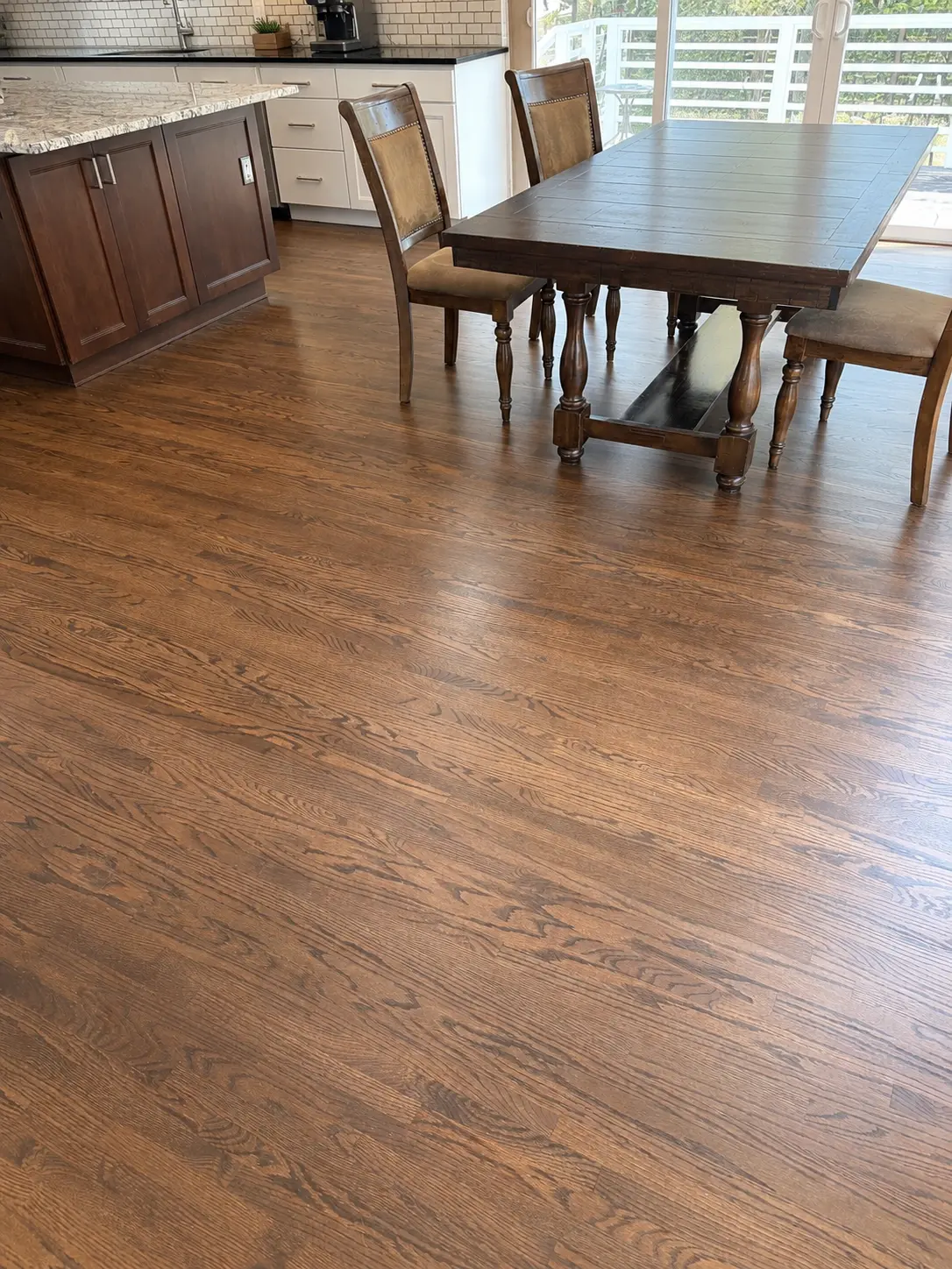 Dark stained red oak floor in a dining room