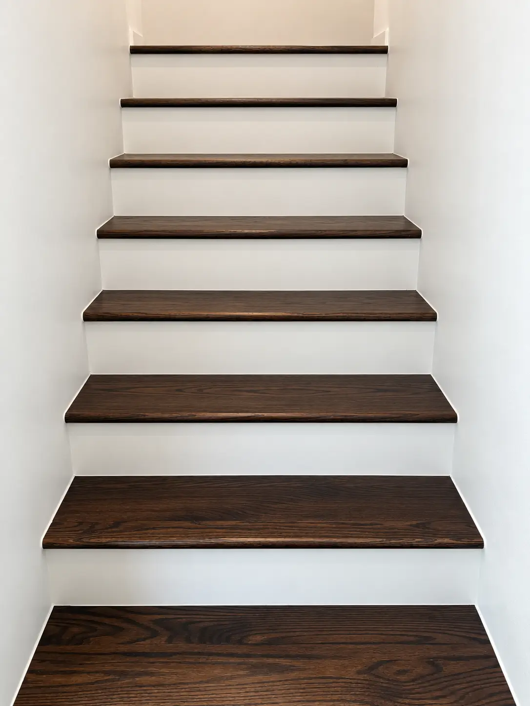 Dark walnut stair treads with white risers