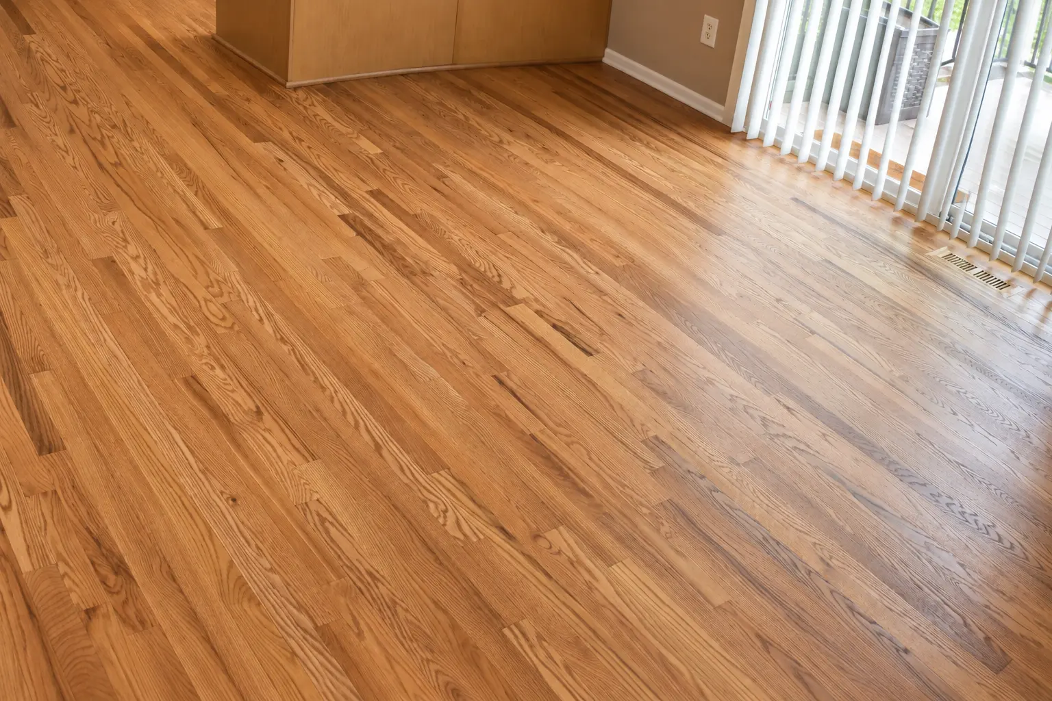 Freshly finished golden oak floor in an empty room