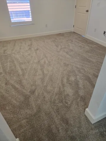 Gray carpet installed across a bedroom floor