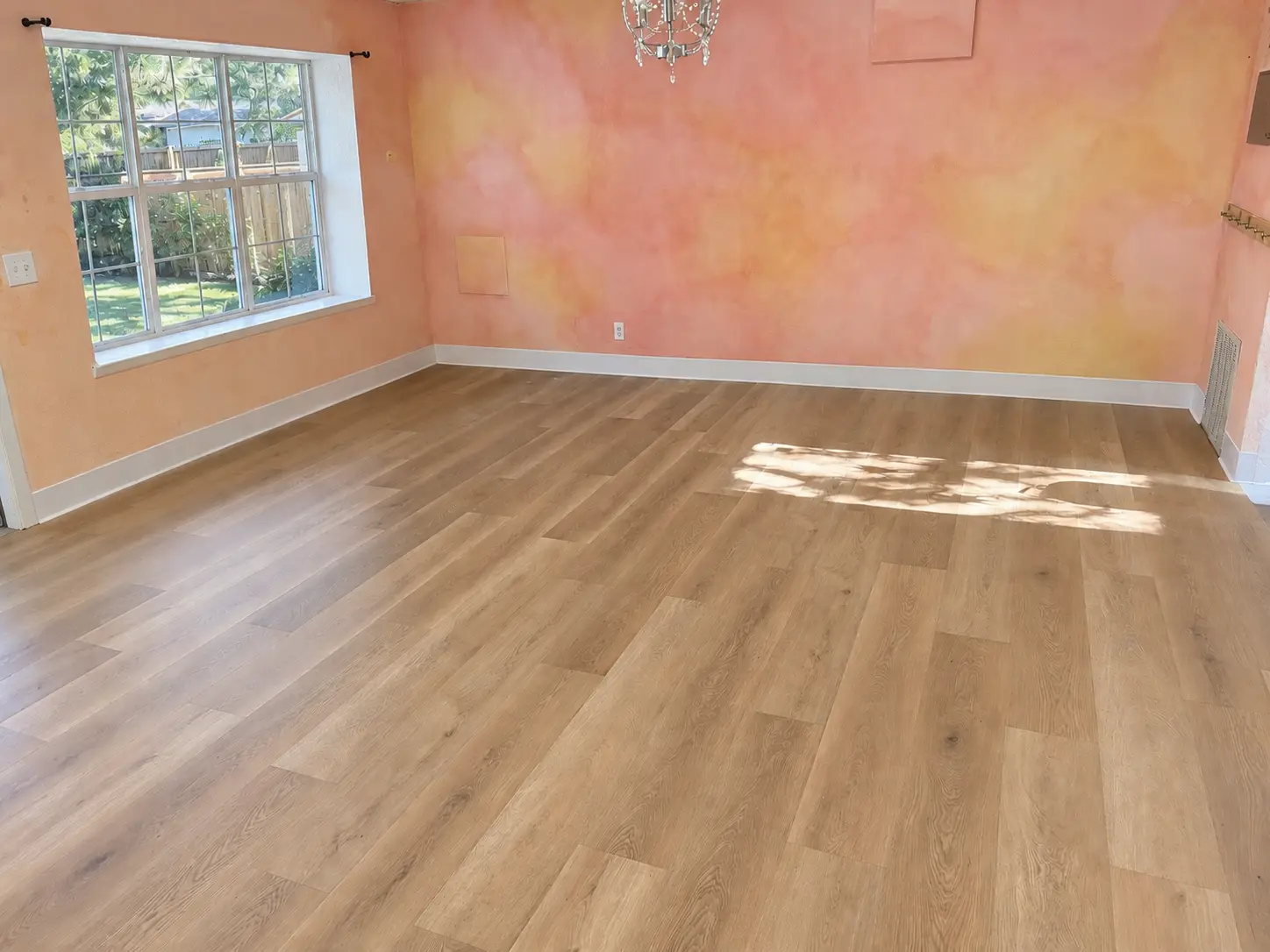 Oak-look luxury vinyl plank in a sunlit room