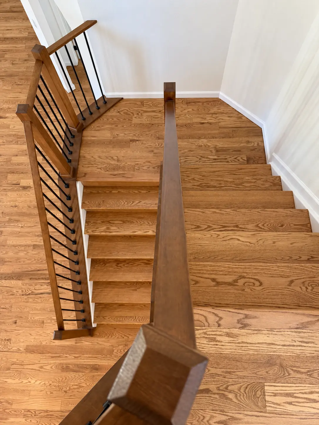 Oak staircase with black metal balusters