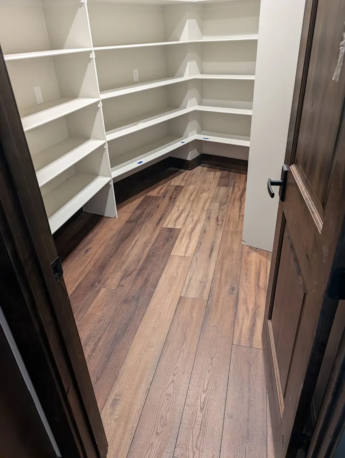 Wide-plank white oak hardwood floor in a walk-in closet