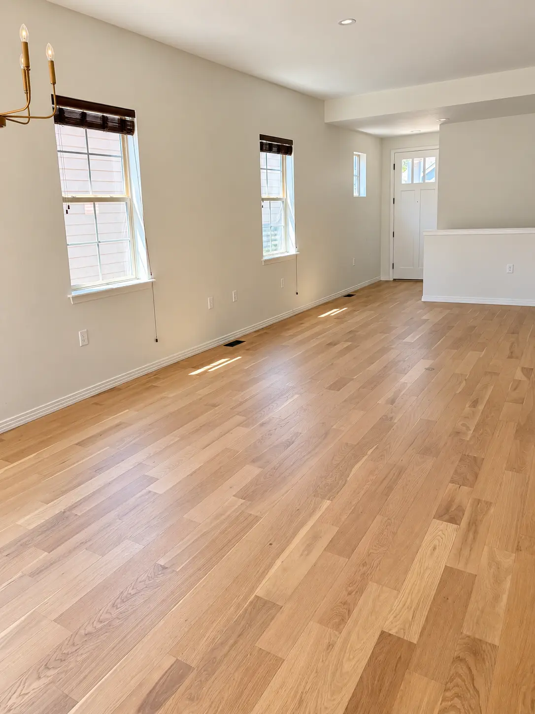 Wide-plank white oak floor in a bright empty room